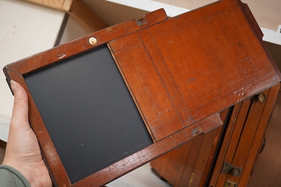 An early 20th century brass mounted mahogany full plate camera, together with a glass negative holder. Condition - fair to good.